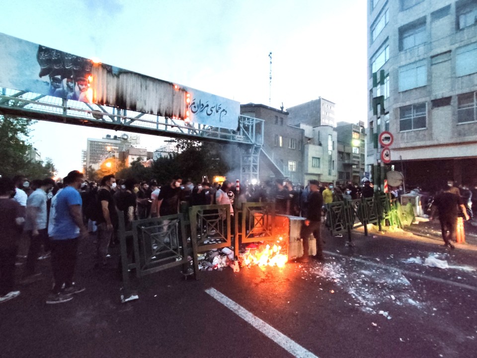Iranian people protesting on the streets in 2022 after the death of a woman killed by Tehran's ruthless morality police