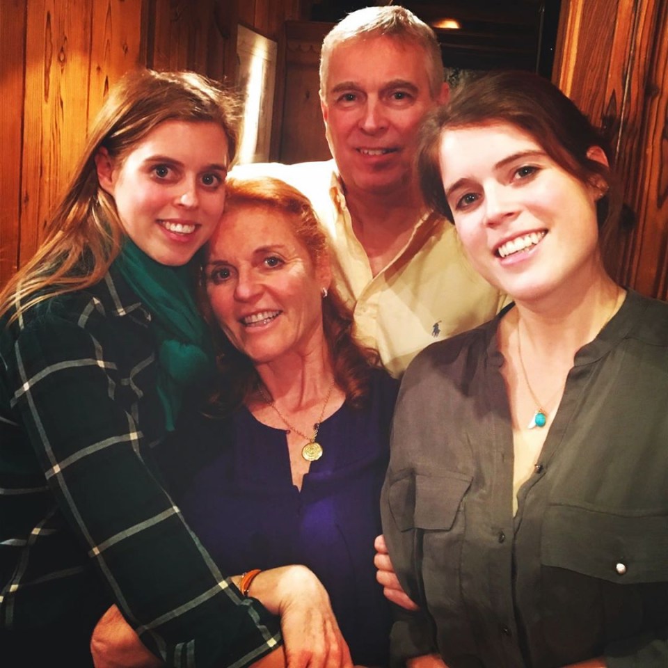 a family posing for a picture with a man wearing a polo shirt