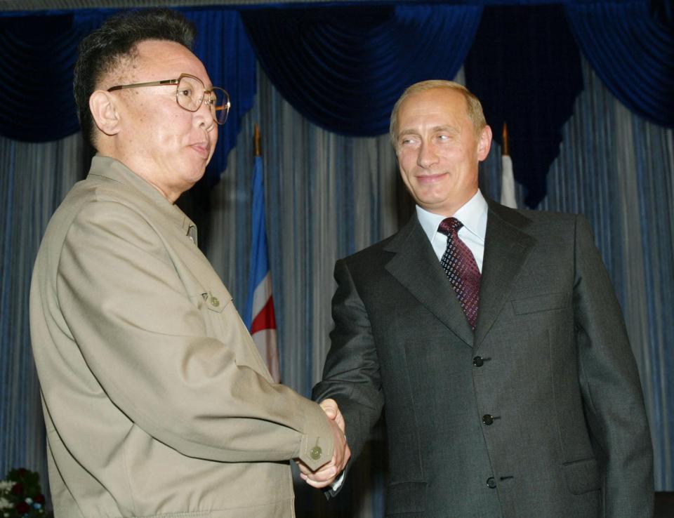 Putin shakes hands with North Korean leader Kim Jong Il in 2002 on his last visit