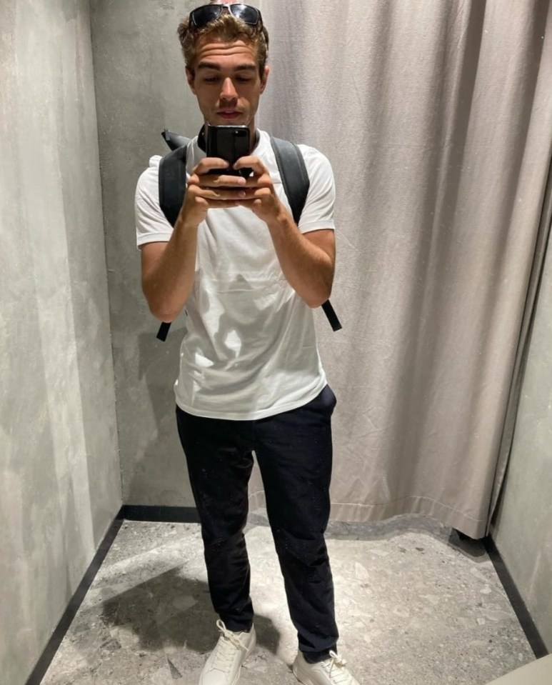 a man taking a picture of himself in a dressing room
