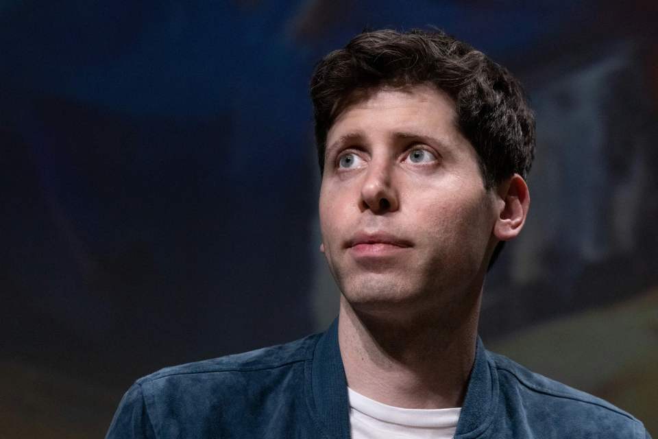 a man wearing a blue jacket and a white shirt looks to the side