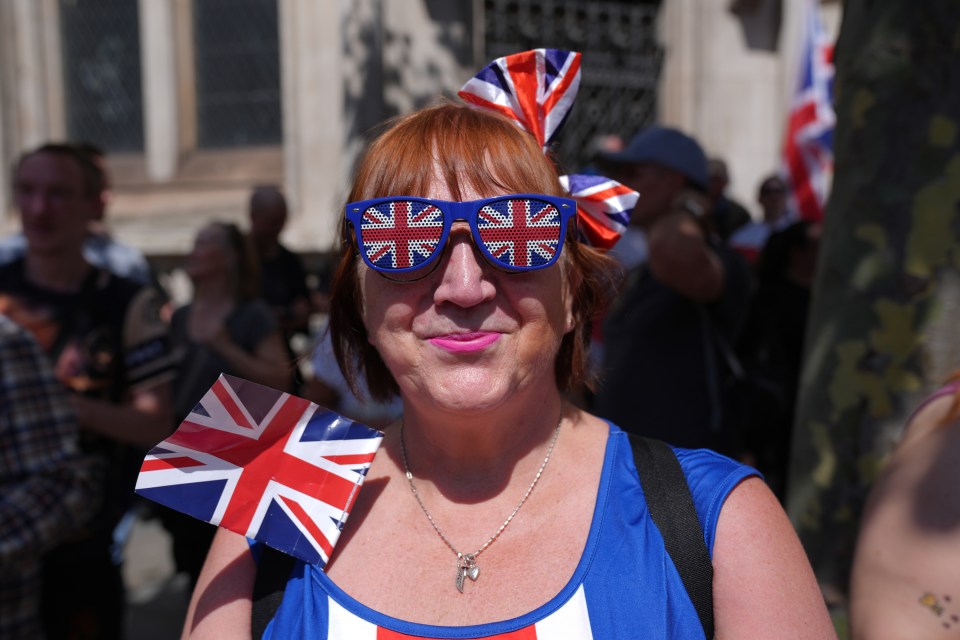 a woman wearing sunglasses with the british flag on them