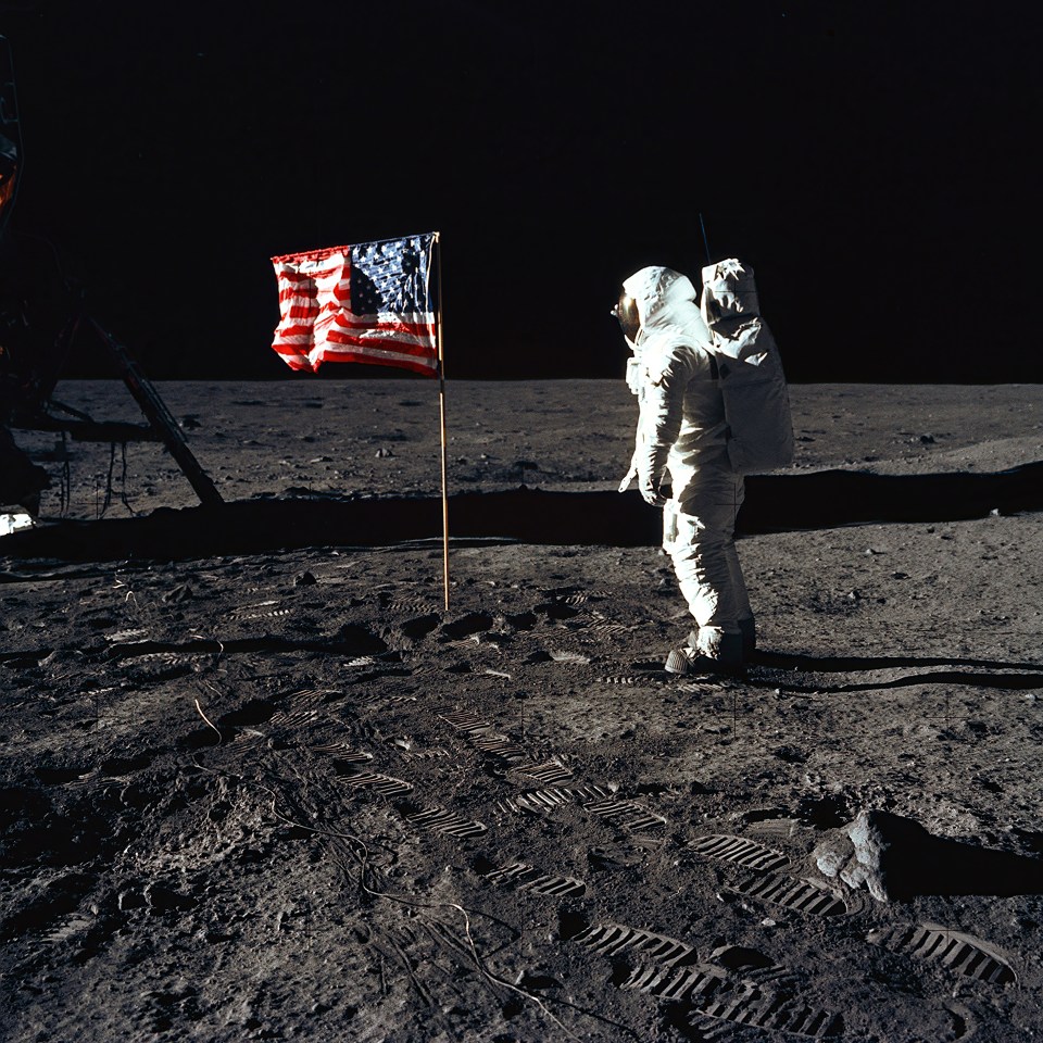 Apollo 11 - NASA, 1969. Astronaut Edwin E. "Buzz" Aldrin, Jr., beside the U.S. flag during an Apollo 11 moon walk. The Lunar Module (LM) is on the left, and the footprints of the astronauts are clearly visible in the soil of the moon. Astronaut Neil A. Armstrong, commander, took this picture with a 70mm Hasselblad lunar surface camera. Artist NASA. (Photo by Heritage Space/Heritage Images via Getty Images)