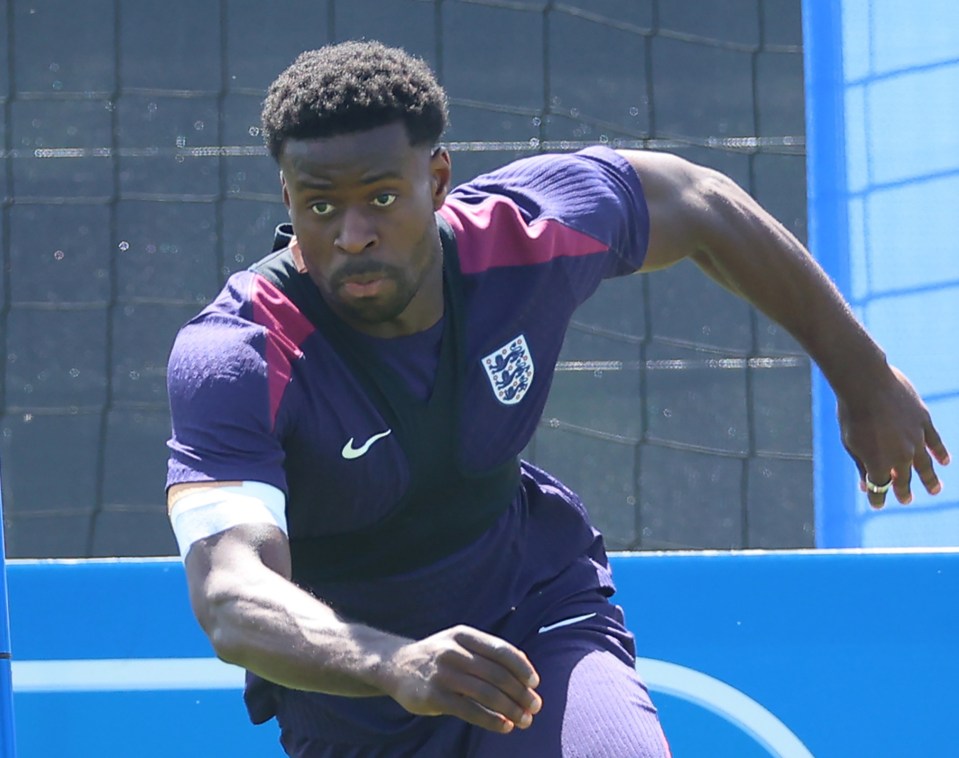 a man wearing a purple shirt with england on it