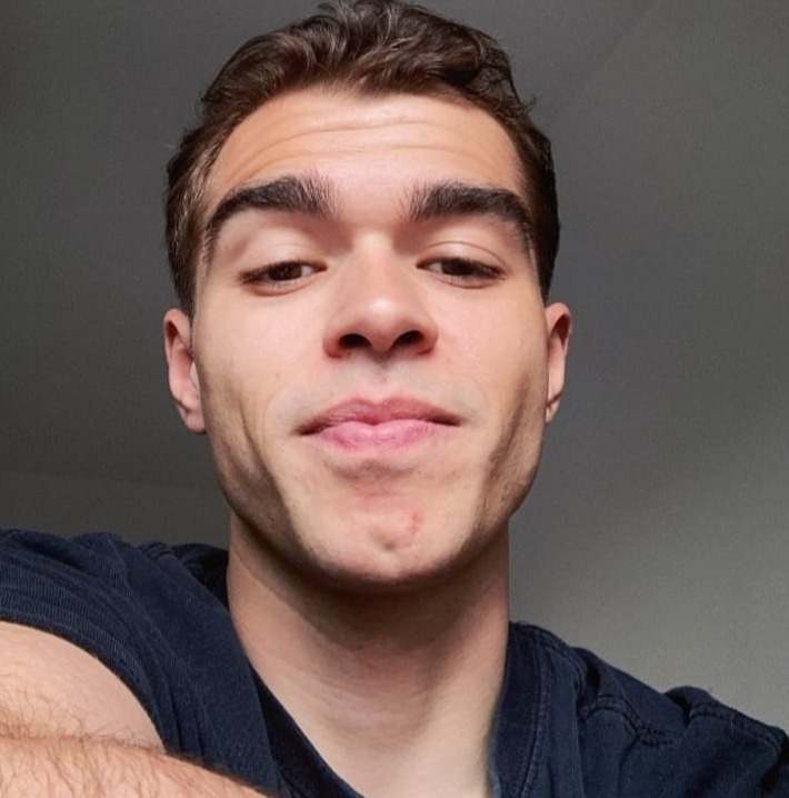 a close up of a man 's face with a smile on his face