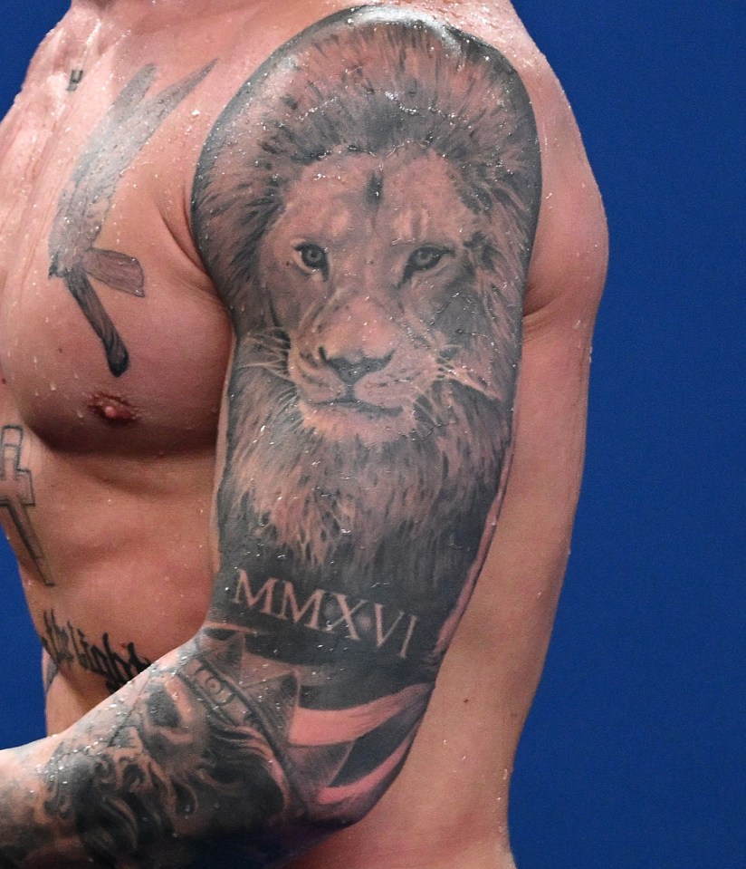 a shirtless man with a tattoo of a lion and the roman numeral mmxii on his arm
