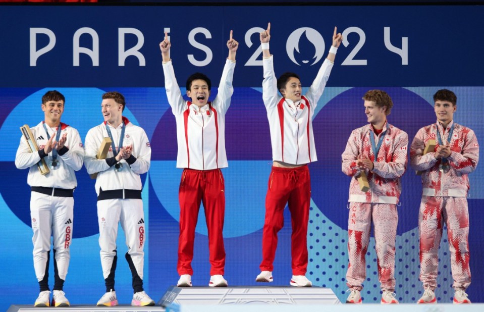 Alamy Live News. 2XMP1T8 PARIS, FRANCE. 29th July, 2024. Gold Medalists Lian Junjie and Yang Hao of Team People's Republic of China celebrate victory while Silver Medalists Tom Daley and Noah Williams of Team Great Britain (L) and Bronze Medalists Rylan Wiens and Nathan Zsombor-Murray of Team Canada (R) stand on the podium during the Diving medal ceremony after the Men?s Synchronised 10m Platform Final on day three of the Paris 2024 Olympic Games at the Aquatics Centre, Paris, France. Credit: Craig Mercer/Alamy Live News This is an Alamy Live News image and may not be part of your current Alamy deal . If you are unsure, please contact our sales team to check.
