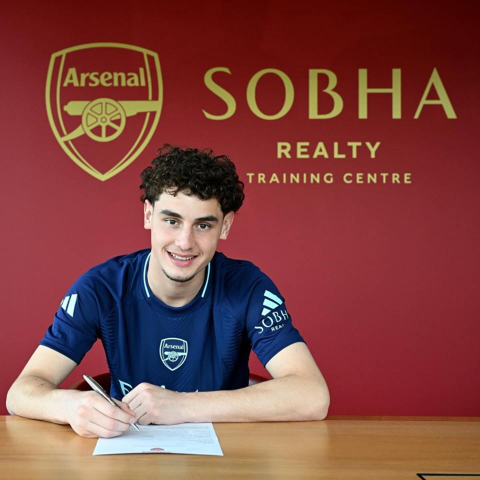 a young man signing a contract in front of a sobha realty training centre