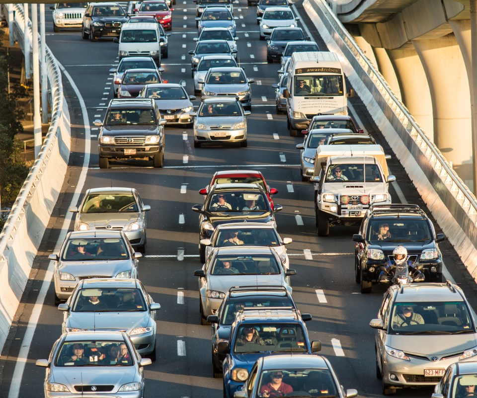 a busy highway with a truck that says ' toyota ' on it