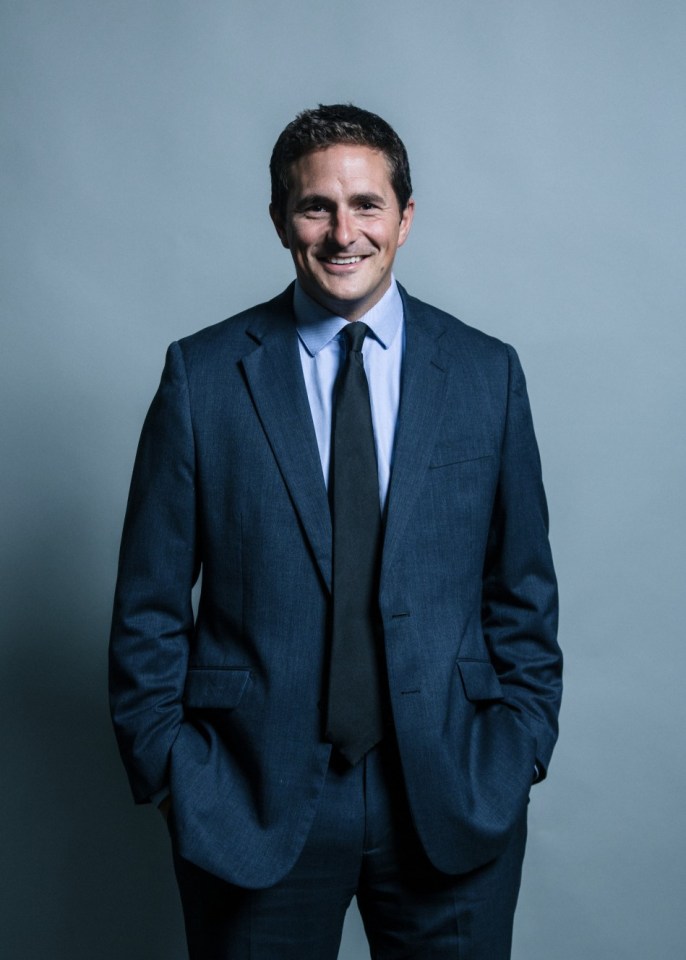 a man in a suit and tie with his hands in his pockets