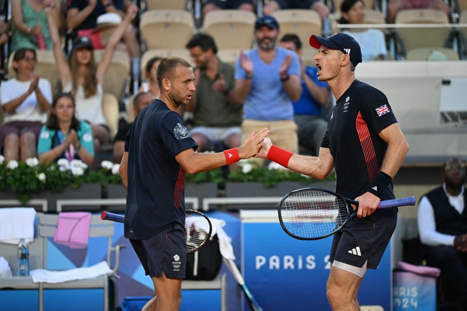 Britain's Andy Murray (R) interacts with Britain's Daniel Evans (L) while playing against Japan's Taro Daniel and Japan's Kei Nishikori during their men's doubles first round tennis match on Court Suzanne-Lenglen at the Roland-Garros Stadium at the Paris 2024 Olympic Games, in Paris on July 28, 2024. (Photo by MARTIN BERNETTI / AFP) (Photo by MARTIN BERNETTI/AFP via Getty Images)