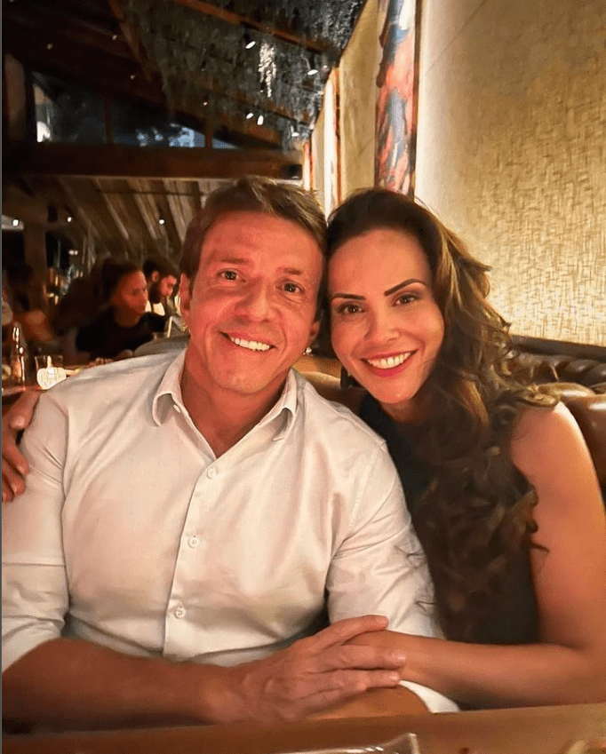 a man and woman are posing for a picture in a restaurant