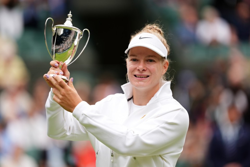 Diede De Groot celebrates with the trophy after victory over Aniek Van Koot (not pictured) on day thirteen of the 2024 Wimbledon Championships at the All England Lawn Tennis and Croquet Club, London. Picture date: Saturday July 13, 2024. PA Photo. See PA story TENNIS Wimbledon. Photo credit should read: John Walton/PA Wire. RESTRICTIONS: Editorial use only. No commercial use without prior written consent of the AELTC. Still image use only - no moving images to emulate broadcast. No superimposing or removal of sponsor/ad logos.
