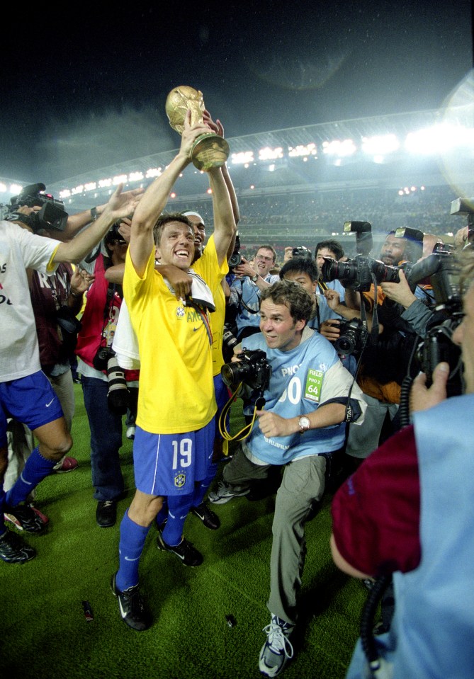 soccer player wearing number 19 holding a trophy