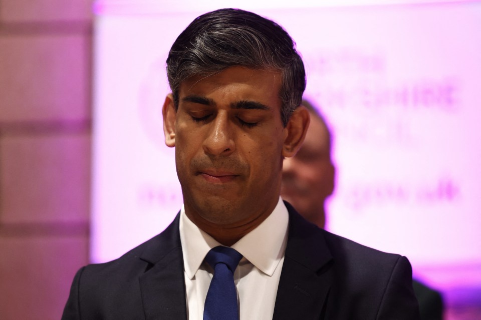 a man in a suit and tie with his eyes closed
