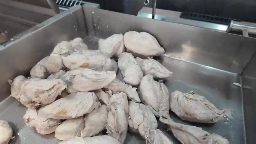 First they have to cook the chicken in a large cooker