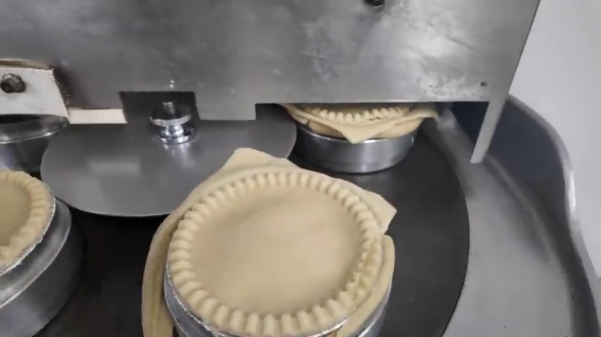 The family add the ingredients to the pie before cooking it in the oven