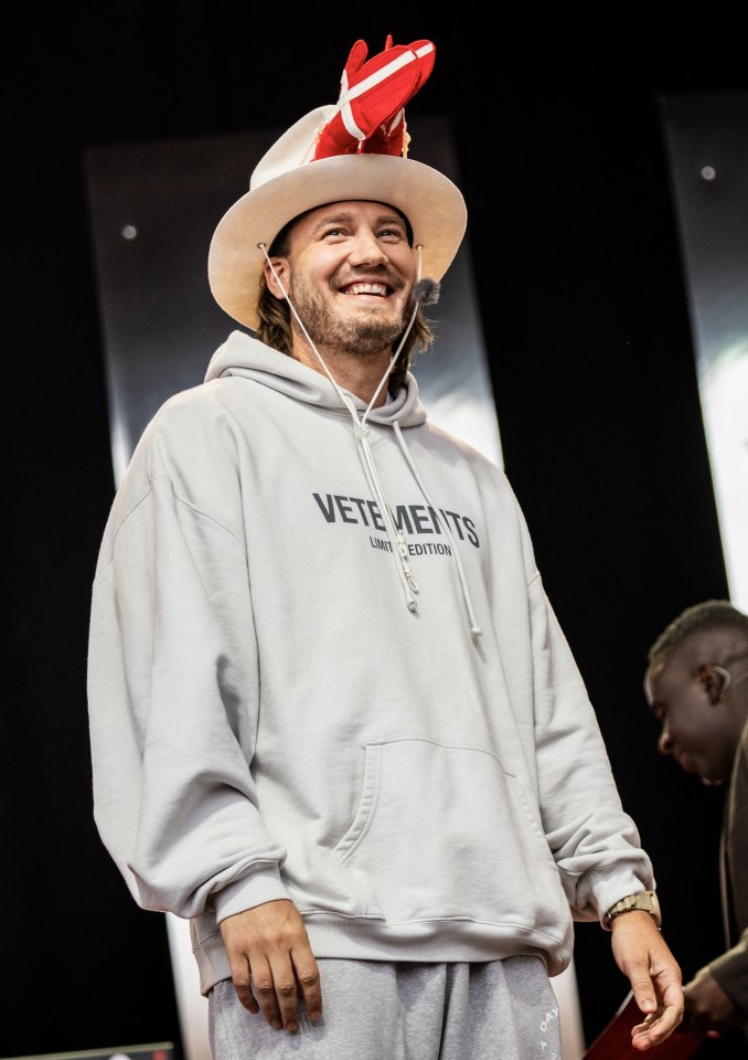 a man wearing a hoodie that says vetements on it