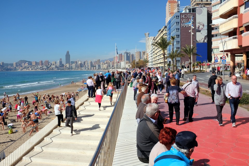 Benidorm, Spain. March 09, 2018. Holidaymakers and locals mingle on the promenade and exercise on the Poniente beach at Benidorm on the Costa Blanca in Spain.