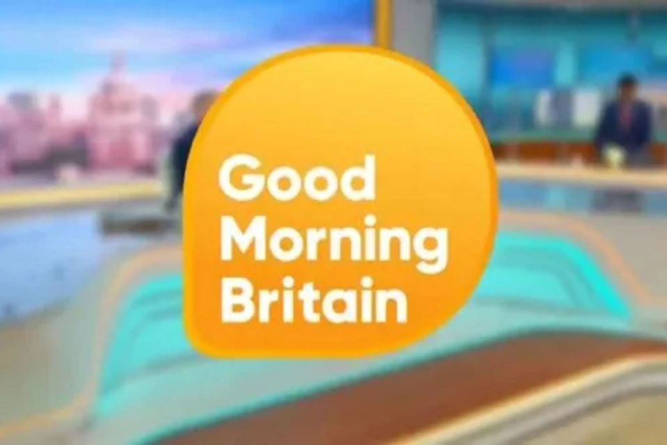 the logo for good morning britain is shown in front of a blurry background .