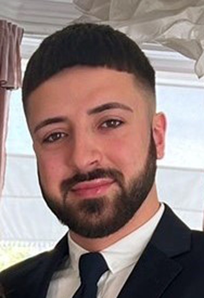 a man with a beard is wearing a suit and tie .
