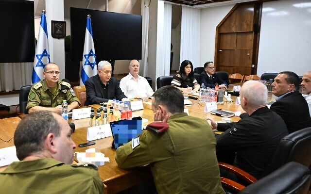 a group of people are sitting around a table with a sign that says ' israeli ' on it