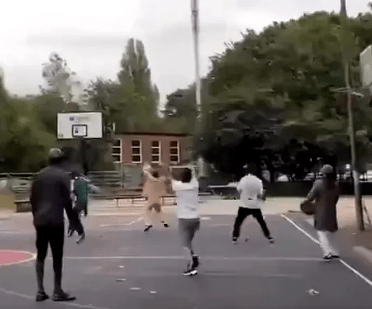 The people on the basketball court were blown away after the ball went into the hoop