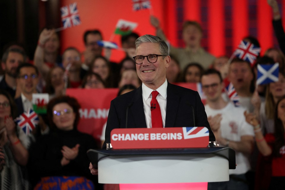a man stands behind a podium that says change begins