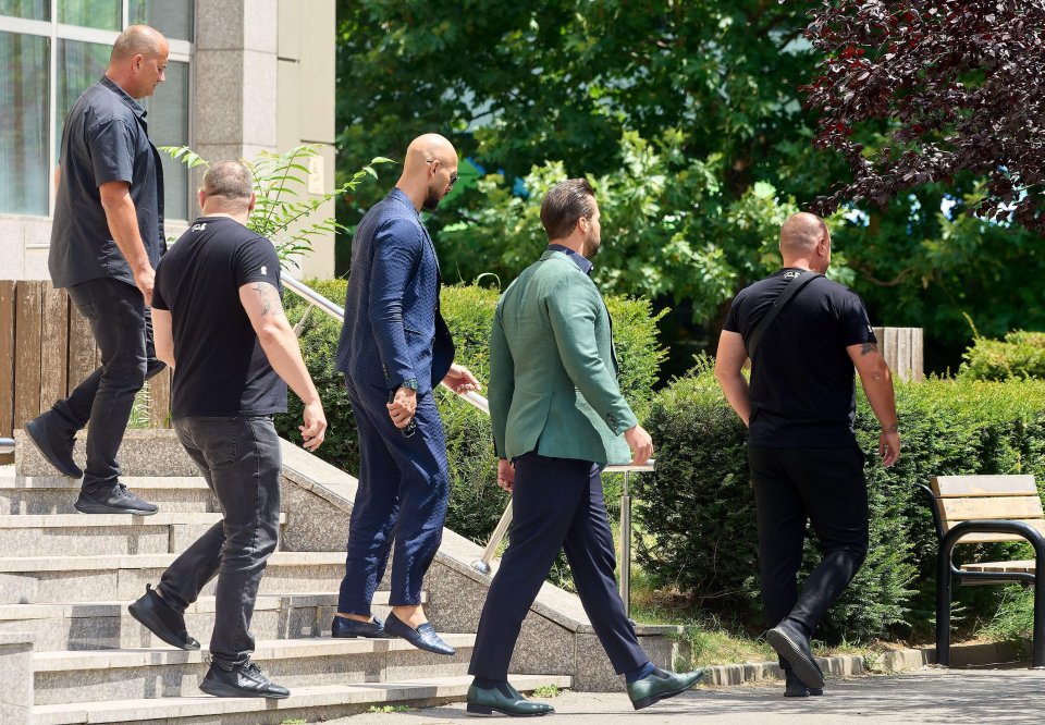 Andrew and Tristan head for a snack during court proceedings on Thursday