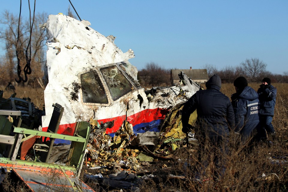 Workers recovering wreckage from the Malaysia Airlines Flight 17 crash site.