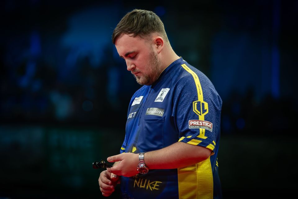 a man wearing a blue and yellow shirt with the word nuke on it