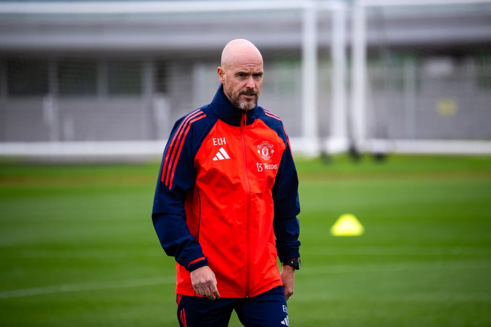 a man wearing a red jacket with the name eh on it