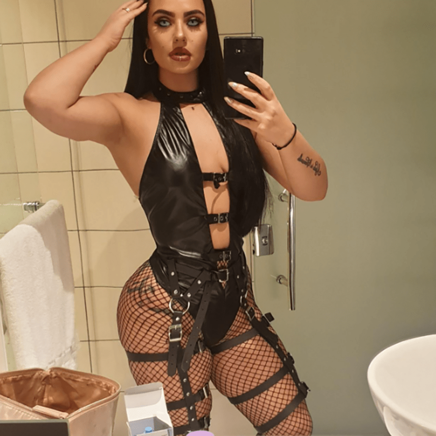 a woman taking a picture of herself in a bathroom