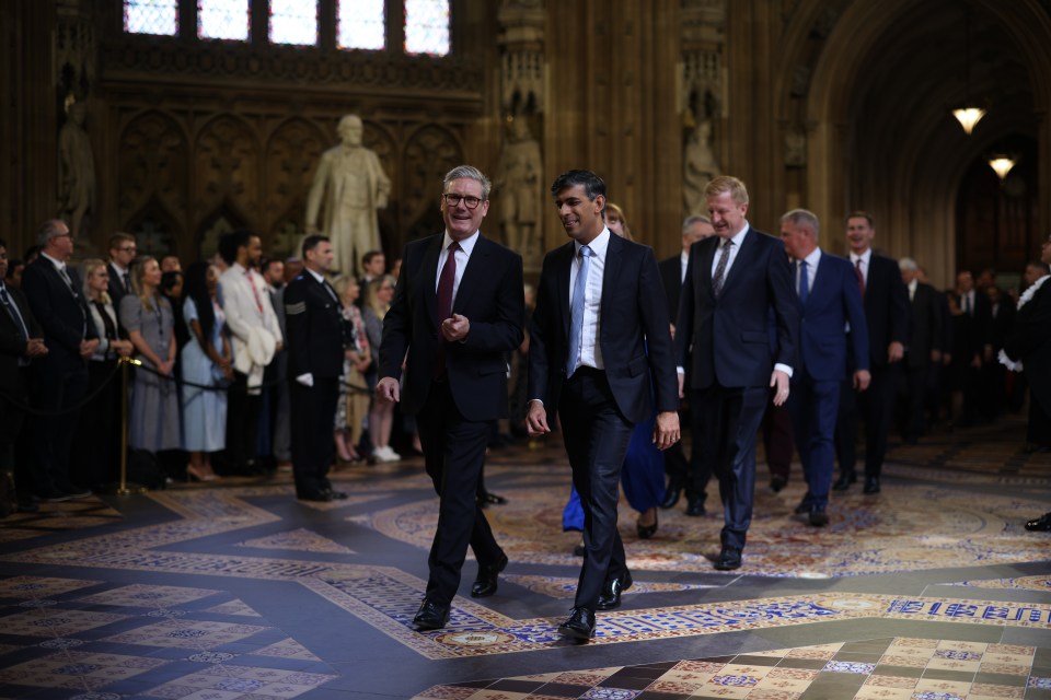 a group of men in suits are walking in a church