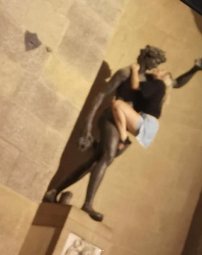 A female holidaymaker was photographed imitating a kiss on a famed statue in Florence