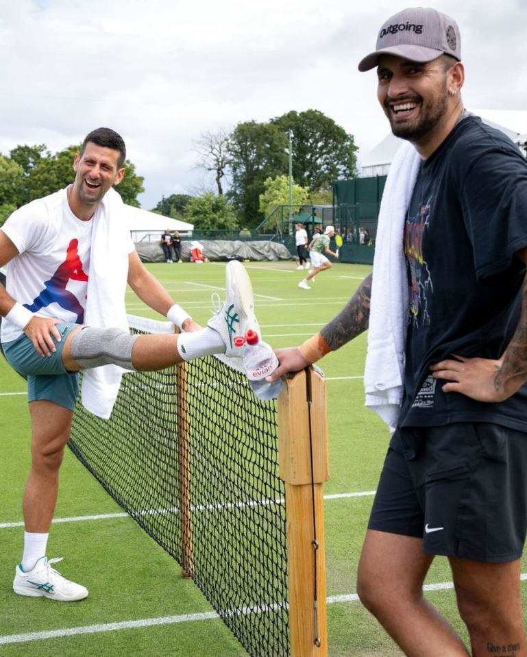 two men on a tennis court with one wearing a hat that says going