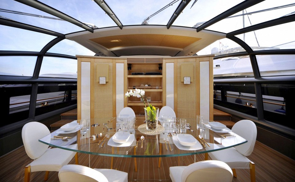 a dining room with a glass table and white chairs