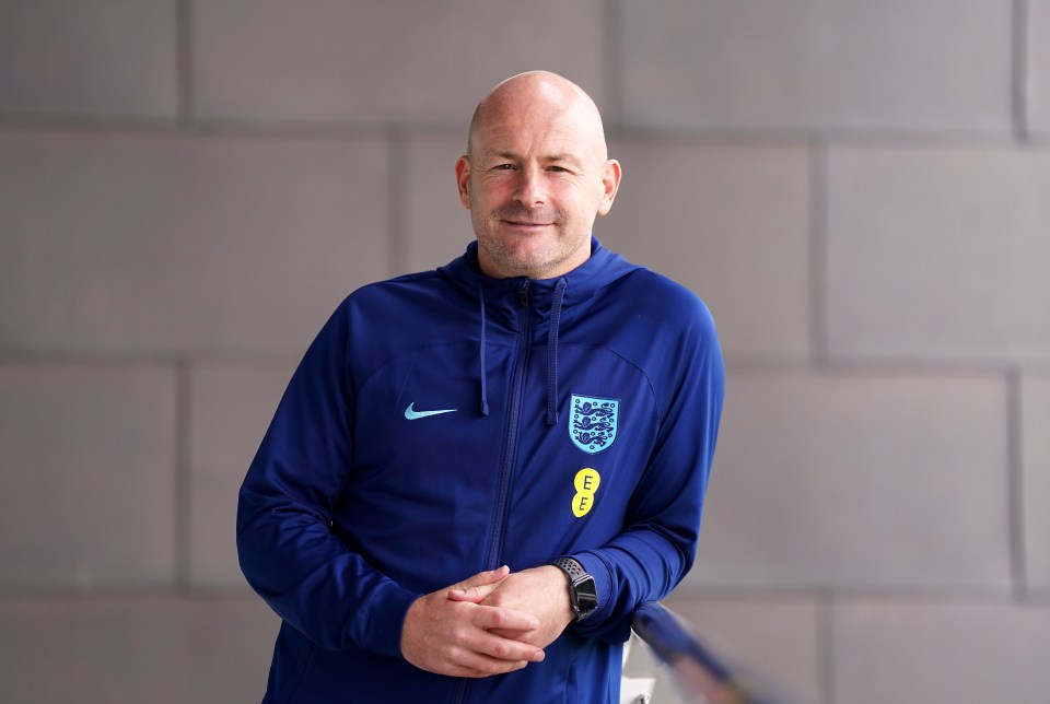 a man wearing a blue nike jacket with an eee logo on the front