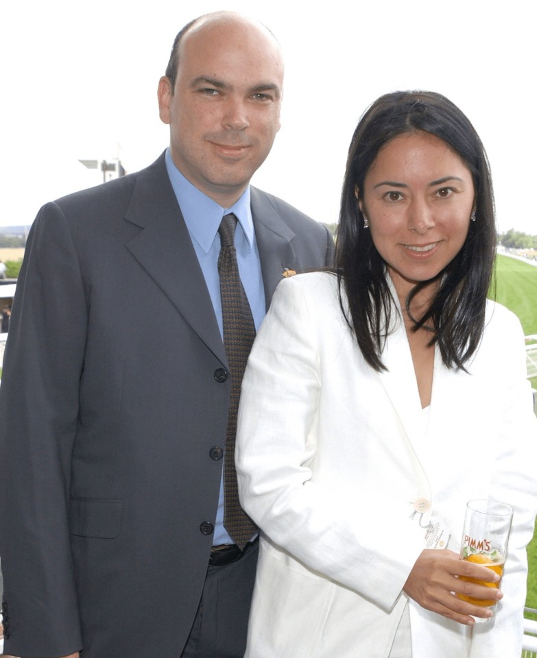 a man in a suit and tie stands next to a woman in a white jacket