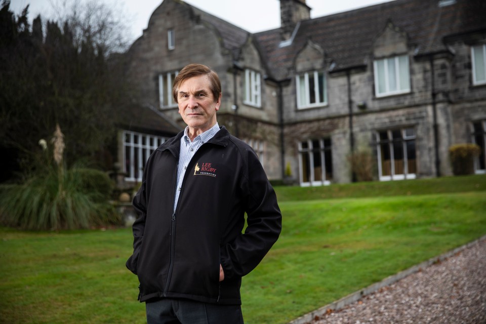 a man wearing a black jacket that says life society