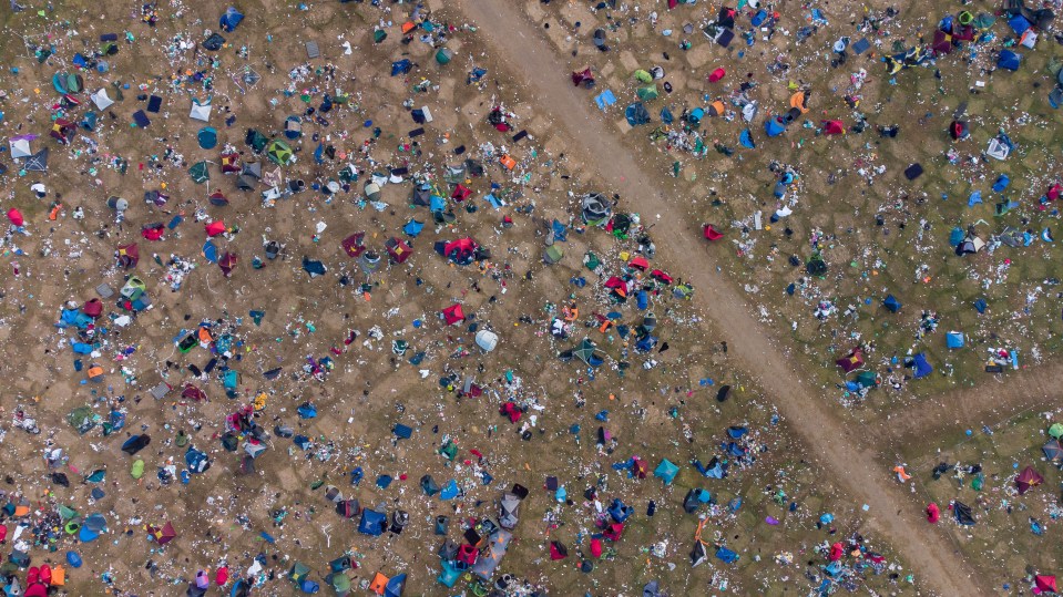 an aerial view of a field filled with tents and trash