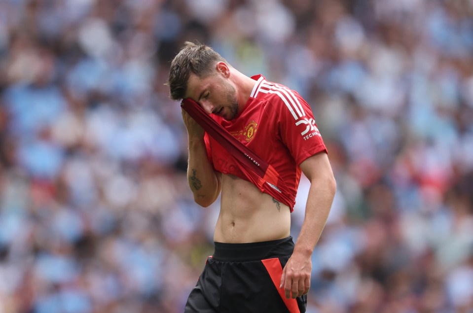 a man wearing a red shirt with the word united on it