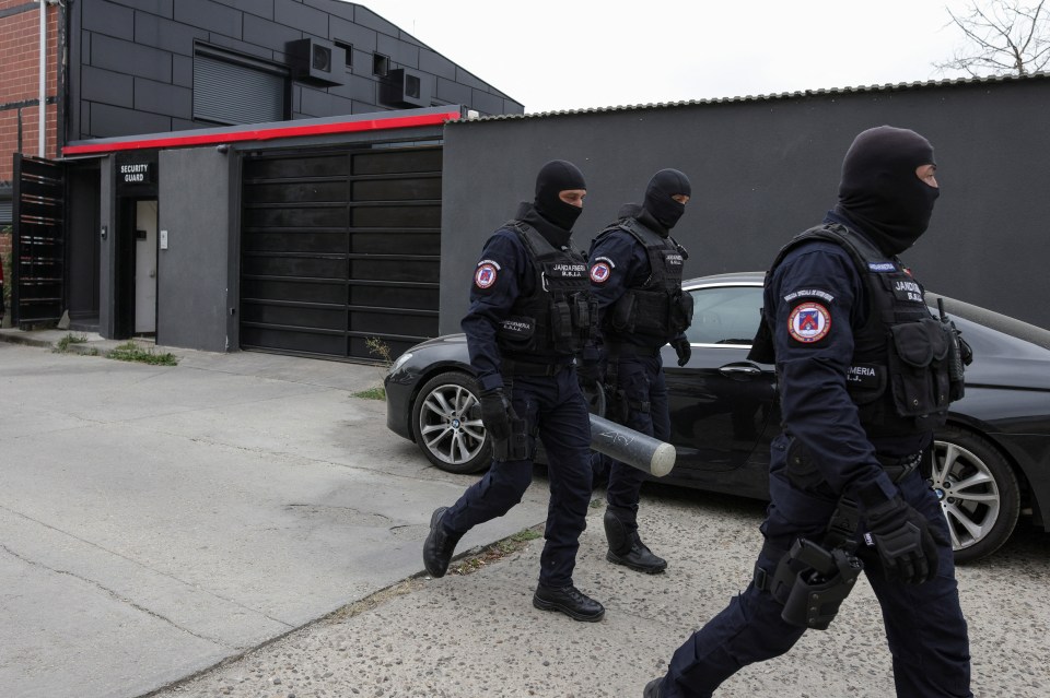a group of security guards are walking in front of a building that says security guard