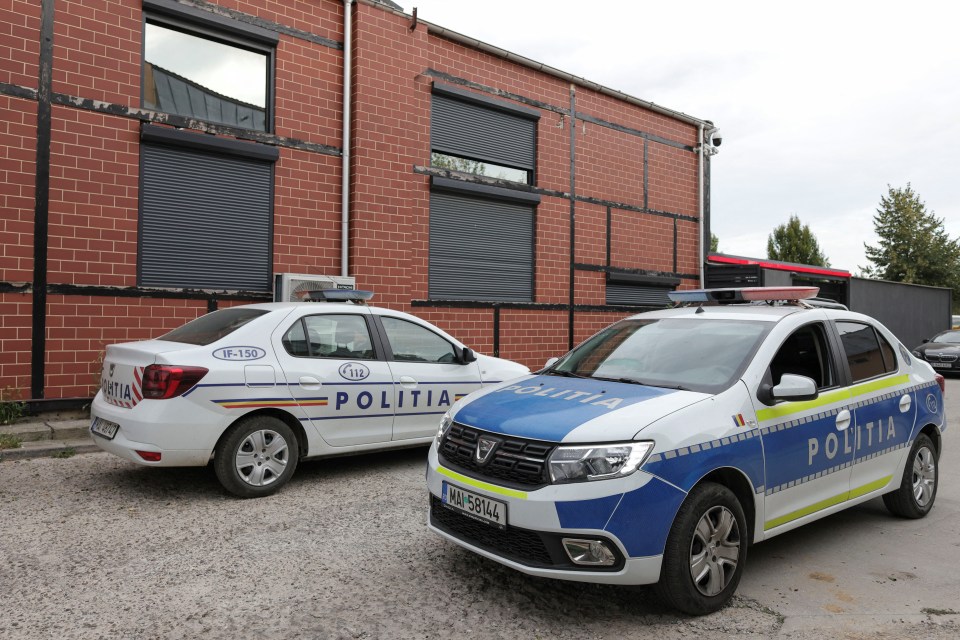 two police cars are parked in front of a brick building