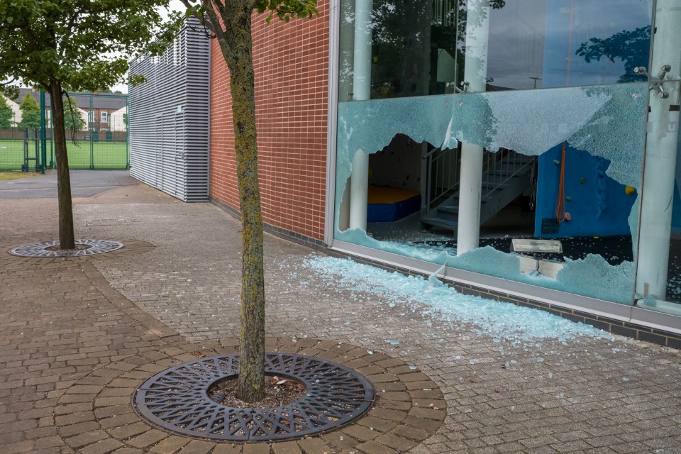 a brick building with a broken glass window