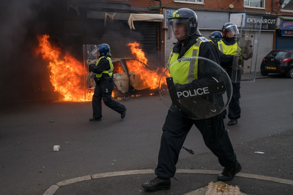 A car burns on Parliament Road in the town amid the chaos yesterday