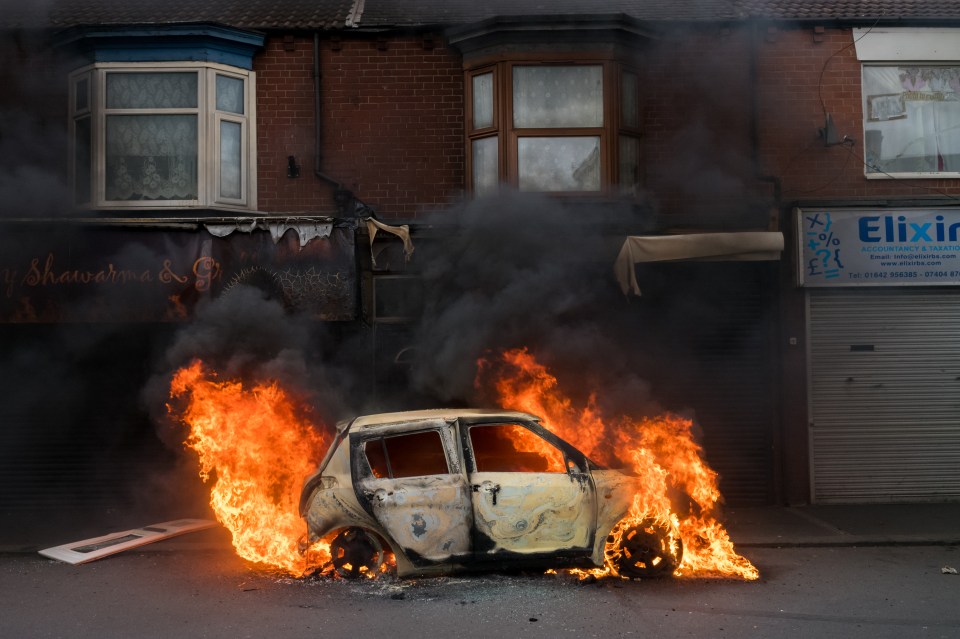 A car burns after it was set alight by far-right activists holding a demonstration in Middlesbrough