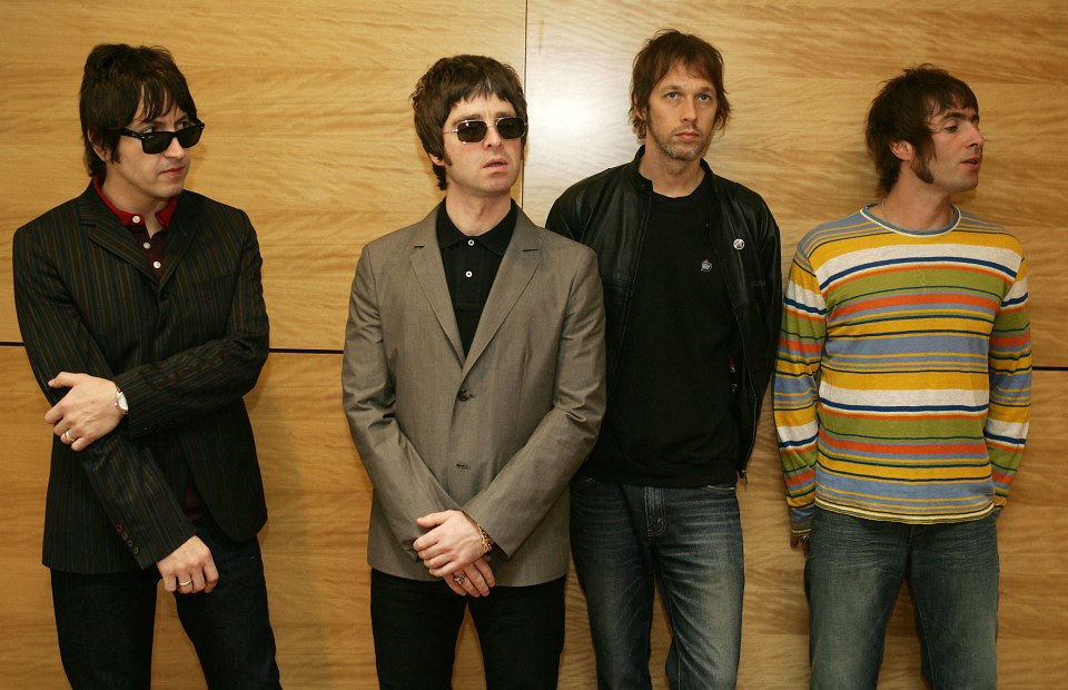 a group of men standing next to each other with one wearing sunglasses