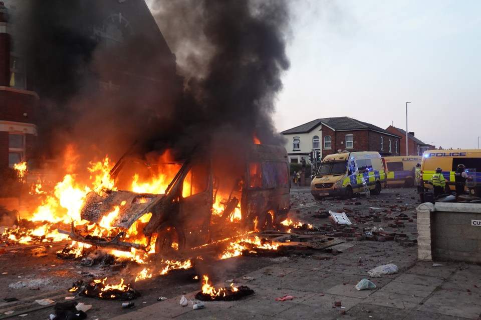 Rioters set police vehicles on fire