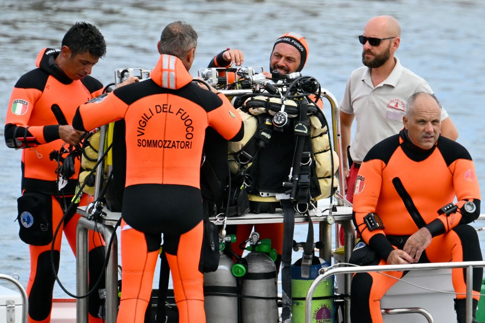 a group of scuba divers are getting ready for a dive